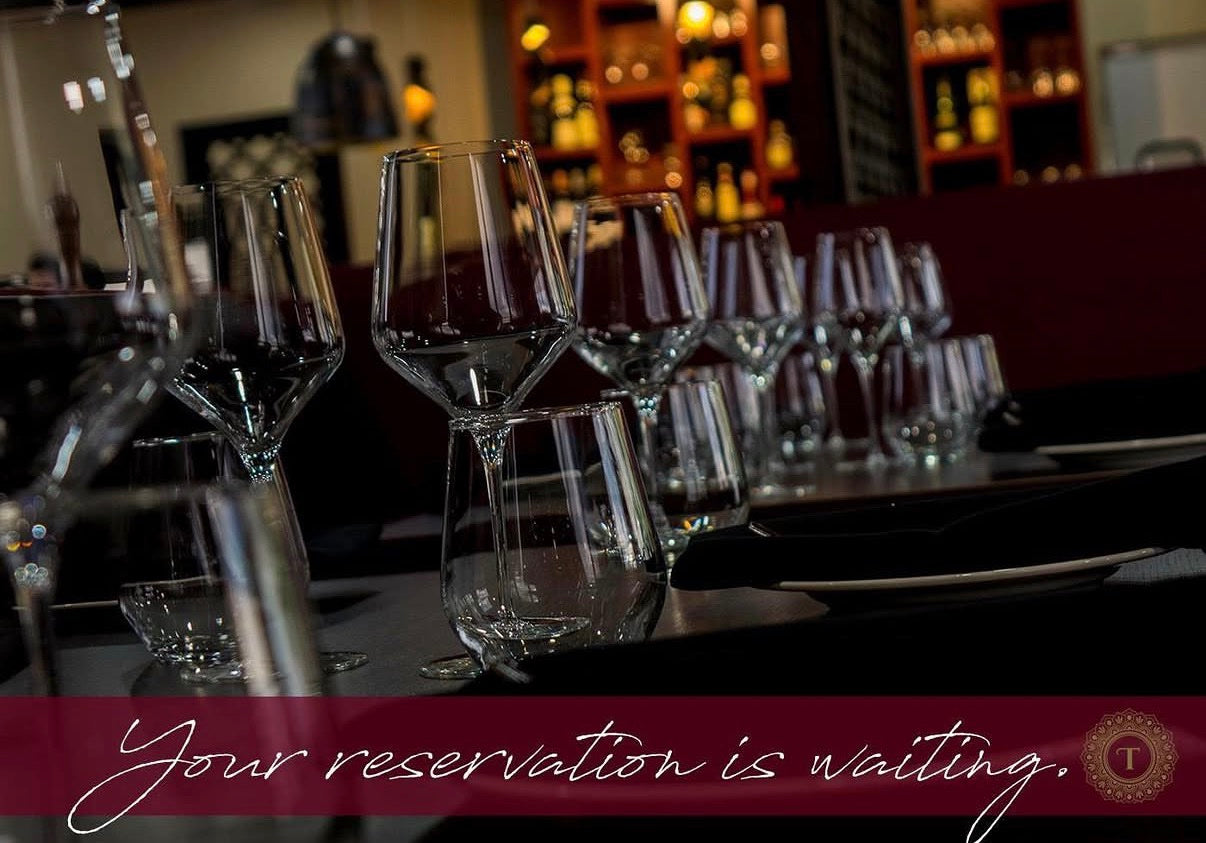 Dining room table set with wine glasses - Your reservation is waiting
